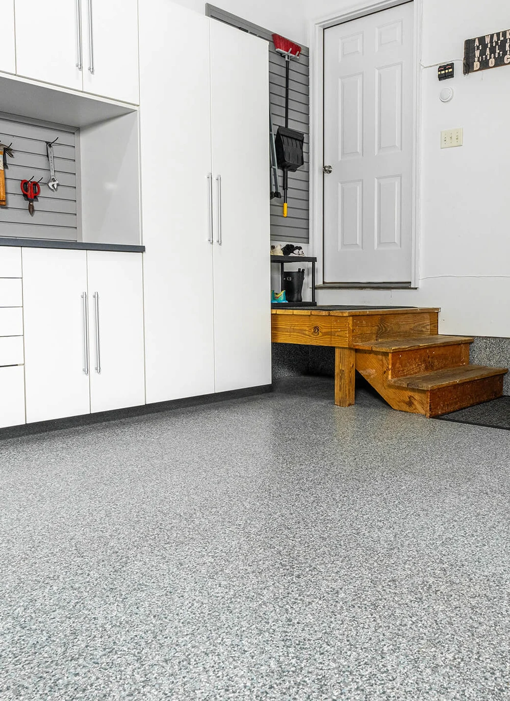 A gray and white flake garage floor in a finished home garage.