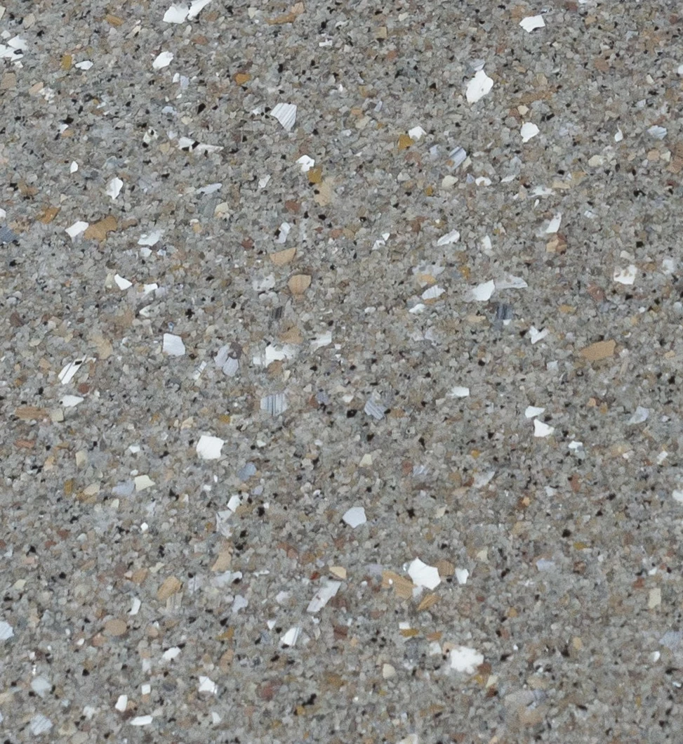 Close-up reference photograph of decorative flake chips under a clear topcoat.